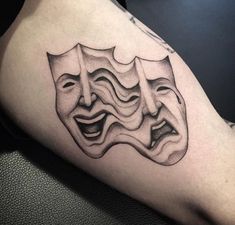 a man's arm with a mask tattoo on it