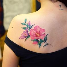 a woman's back shoulder with flowers painted on the upper part of her body