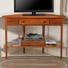 a flat screen tv sitting on top of a wooden stand next to a window sill