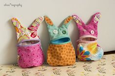 three stuffed animals are lined up on a table