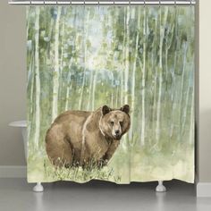 a shower curtain with a brown bear standing in the woods on it's side