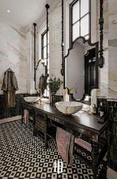 an ornate bathroom with black and white tile flooring, two sinks and large mirrors