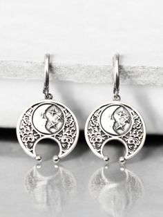 Embrace the mystique of the moon with these stunning half moon earrings. Handcrafted from high-quality sterling silver, these lunula earrings feature an intricate design inspired by Viking jewelry and celestial themes. Perfect for those who love boho style and lunar symbolism, these earrings capture the beauty and mystery of a lunar eclipse. These sterling silver lunula earrings are both elegant and durable, making them ideal for everyday wear or special occasions. The detailed craftsmanship reflects the timeless appeal of Viking jewelry while adding a modern boho twist. Whether you're looking for a unique accessory or a thoughtful gift, these half moon earrings are a perfect choice. Celebrate the celestial charm and Viking heritage with these exquisite half moon earrings. Their handcrafte Celestial Moon-shaped Pierced Cartilage Earrings, Celestial Moon Shaped Pierced Cartilage Earrings, Silver Moon Shaped Symbolic Jewelry, Celestial Silver Pierced Jewelry, Symbolic Silver Moon-shaped Jewelry, Symbolic Moon Shaped Silver Jewelry, Symbolic Silver Moon Jewelry, Celestial Style Silver Jewelry, Celestial Crescent Cartilage Earrings