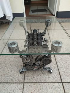 a table made out of engine parts sitting on the floor