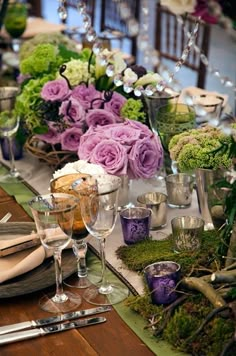 an assortment of flowers and condiments sit on a table in front of some jars