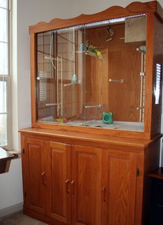 a wooden cabinet with glass doors in a room