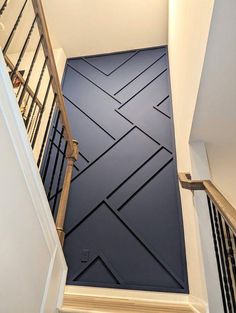 a stair case with black tiles on the floor