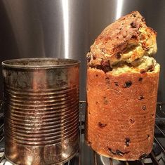 a loaf of bread sitting on top of an oven rack next to a tin can