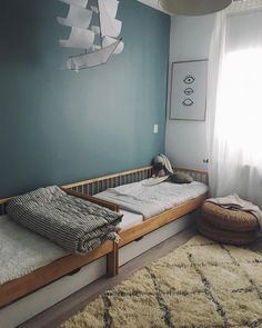 a bedroom with two twin beds and a rug on the floor in front of it