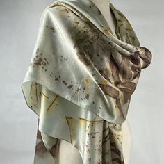 Discover Timeless Elegance with my Luxurious Hand-Dyed Eco-Printed Scarf Elevate your style with my exquisite silk satin scarf, a masterpiece of nature-inspired art and unparalleled craftsmanship. Each piece is hand-dyed and eco-printed, ensuring a unique and sustainable accessory that embodies the beauty of the natural world. Gray with a hint of light this accessory is perfect as a scarf or shawl. It will add a touch of sophistication to any outfit, whether casual or formal! Wrap yourself in elegance and make every moment special with a scarf that reflects your style and values. Embrace the fusion of art and nature with our luxurious hand-dyed eco-printed scarf. Order yours today and experience the difference of truly unique, handcrafted fashion. Light weight, this scarf is approximately Silk Shawl Scarf, Bohemian Hand-dyed Silk Scarf, Artistic Silk Wedding Scarves, Artistic Silk Scarves For Wedding, Artistic Silk Scarves For Weddings, Silk Shawl For Wedding, Satin Shawl, Green Silk Scarf, Sustainable Accessories