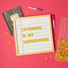 the words learning is my super power written on a piece of paper next to some school supplies