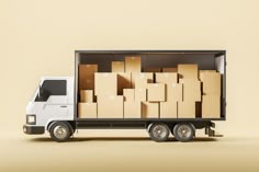 a delivery truck with cardboard boxes on the back in front of a beige wall background