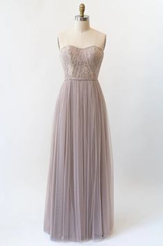 a dress on a mannequin with a strapless top and tulle skirt