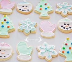 decorated cookies are arranged on a white surface