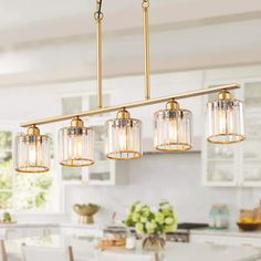 an image of a kitchen light fixture with clear glass shades on the bottom and sides