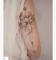 a woman with a flower tattoo on her arm