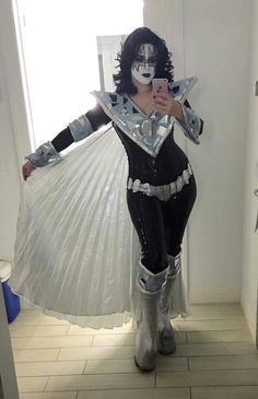 a woman dressed in costume taking a selfie