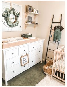 a baby's room with a dresser, crib, and changing table in it