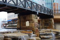 the water is running under the bridge and into the building's courtyard area,