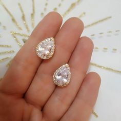 two pairs of diamond earrings in the palm