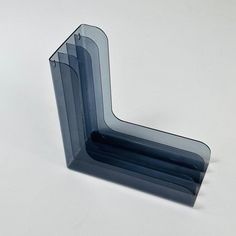 three pieces of glass sitting on top of a white table next to each other,