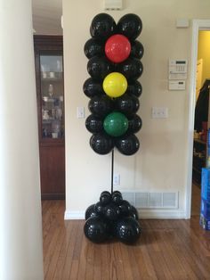 a bunch of balloons that are in the shape of a tree on a wooden floor