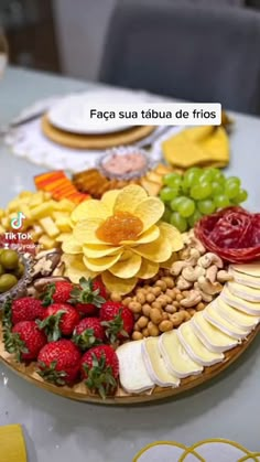 a platter filled with fruits and vegetables on top of a table