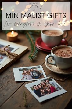 two cups of coffee and three polaroid photos on a table with christmas lights in the background