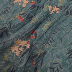 the fabric is green with orange flowers on it