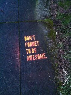 a sidewalk with graffiti written on it that says don't forget to be awesome