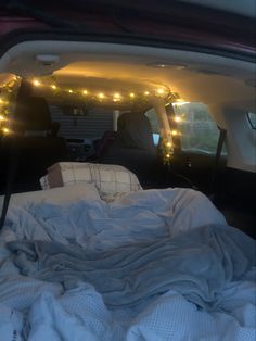 there is a bed in the back of a truck with lights on it's sides