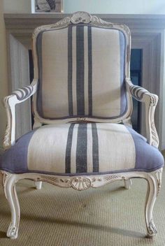 an old chair with blue and white stripes on it