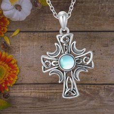 This Celtic Cross Necklace features a beautiful round moonstone in the center, radiating a soft blue glow that exudes romance and mystery. The cross symbolizes faith and protection, while the moonstone offers peace and tranquility to the wearer, making it a truly captivating piece. Material: Made of 925 sterling silver with a synthetic high-grade moonstone. The necklace is expertly polished and plated, hypoallergenic, and eco-friendly, free from nickel and lead. Size: The Celtic cross pendant me Celtic Knot Cross, Celtic Cross Necklace, Sterling Silver Cross Necklace, Blue Glow, Celtic Cross, Celtic Jewelry, Moonstone Necklace, Necklace Sterling Silver, Celtic Knot