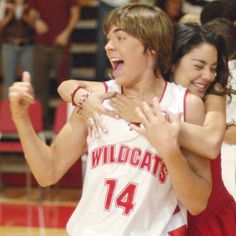 two young people are hugging each other on the basketball court