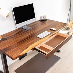 a desk with a computer monitor, keyboard and mouse