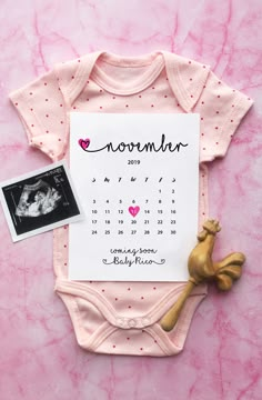 a baby's birth announcement is displayed on a pink background with a photo and a toy