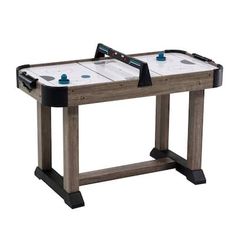 the air hockey table is made from wood and has two pieces of plastic on top