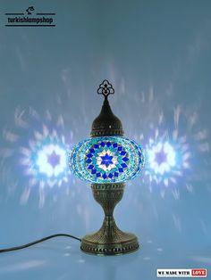 an ornate lamp with blue and white designs on the top is shown in front of a blue background