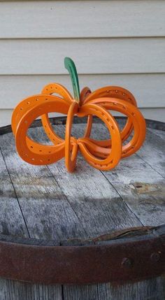 an orange pumpkin sitting on top of a wooden table