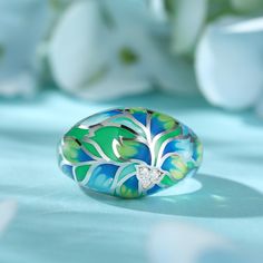 How beautiful is this sweet spring ring? The ring features flowers and leaves that wrap around your finger, detailed with bright enamel for lovers of colour! The perfect accessory for spring and summertime, or to keep the floral vibe going all year round.Carat Weight: 0.072 ctStone Size: 1.4 mmNumber of Stones: 3 Stone Shape: RoundStone Color: Diamond WhiteWeight: 4.79 gWidth: 3.7 mmHeight: 7.7 mmThickness: 1.6 mmMaterial: 925 SilverPlating Color: Silver Enamel Jewelry For Spring Gifts, Spring Enamel Jewelry As Gift, Spring Enamel Jewelry For Gifts, Spring Gift Enamel Jewelry, Green Rings As Summer Gift, Green Rings Suitable For Summer Gifts, Green Rings For Summer Gifts, Hand Painted Jewelry For Spring, Spring Hand Painted Jewelry