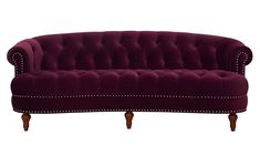 a purple couch with wooden legs and studded trim