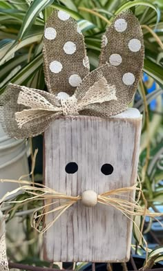 a wooden block with a face made out of burlocks and polka dots on it