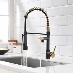 a kitchen faucet that is running water from it's spigot