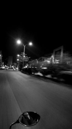 a person riding a motorcycle down a street at night