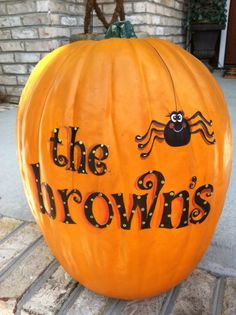 a pumpkin with the words, the browns on it sitting in front of a brick building