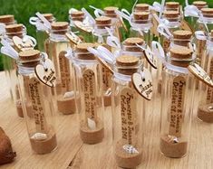 small bottles filled with sand sitting on top of a wooden table