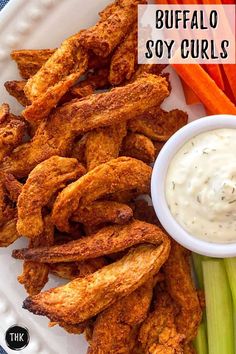 buffalo soy curls on a plate with ranch dip and celery sticks next to it