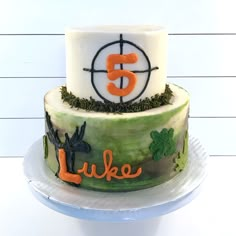 a three tiered cake with the number five on it