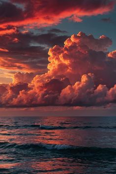 the sun is setting over the ocean with clouds in the sky and water below it