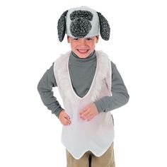 a little boy that is wearing a dog hat and vest with his hands in his pockets